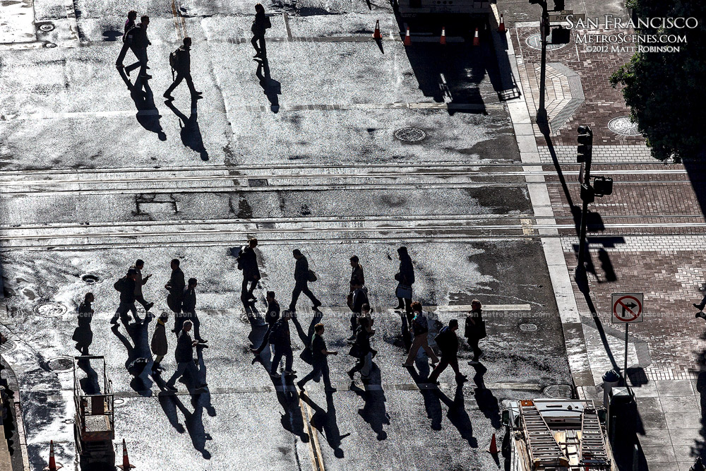 Pedestrians cross Ellis Street in the morning