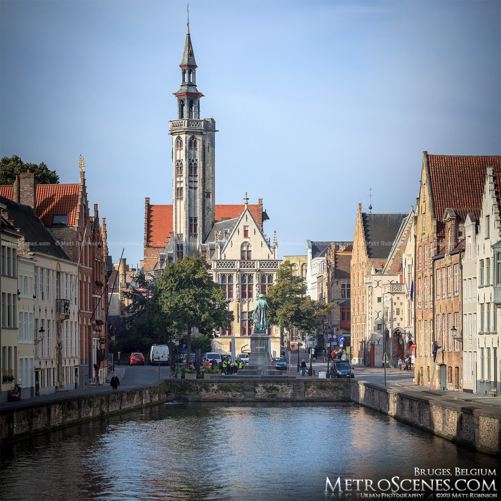 The Poortersloge and Jan van Eyck Statue at the end of Spiegelrei Canal in Bruges, Belgium