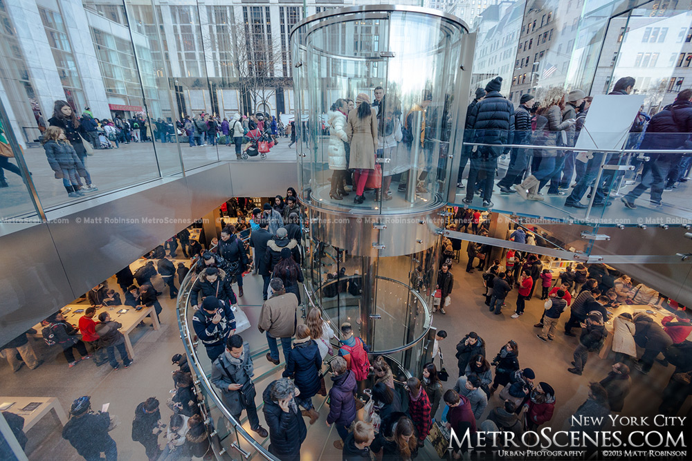 Hundreds of people browse the NYC Apple Store on Fifth