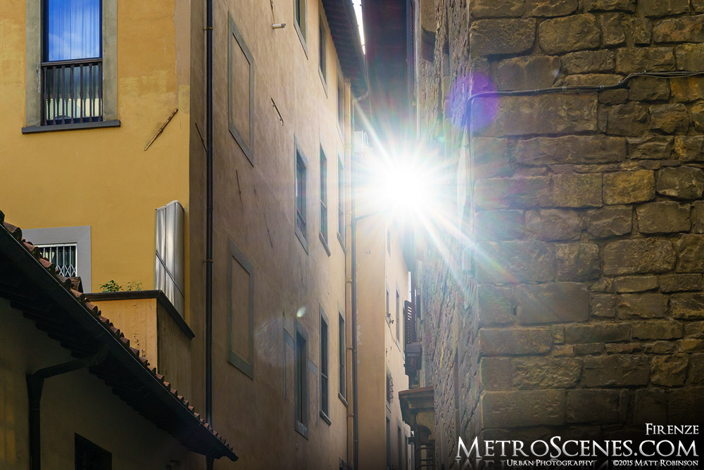 Sun peeks through buildings in Florence