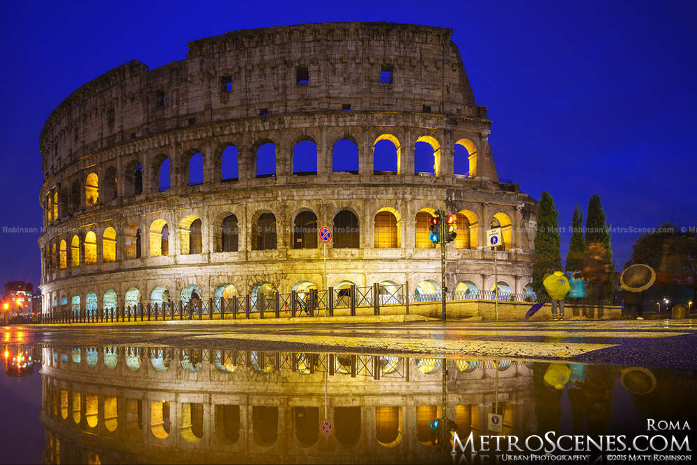 A puddle reflects the ancient Roman Colosseum