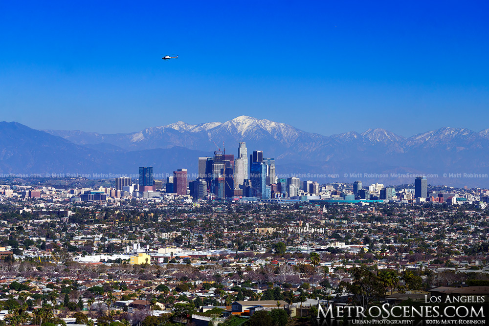 Downtown LA with snow and mountains
