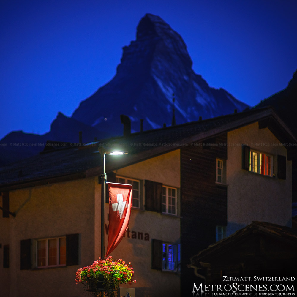 Swiss flag and the Matterhorn at night