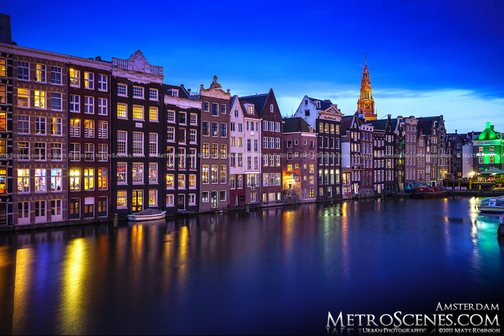 Damrak Canal with Amsterdam Houses with Oude Kerk